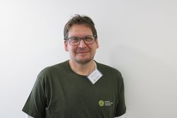 Das Bild zeigt Naturparkführer Marcus Wilcke in dunkelgrünem T-Shirt. Er hat kurzes dunkles Haar und eine Brille.